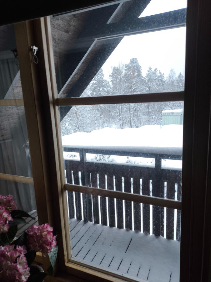 Balcony view into the snow. West Cottage Sweden, Åsensbruk Balcony view into the snow. West Cottage Sweden, Åsensbruk